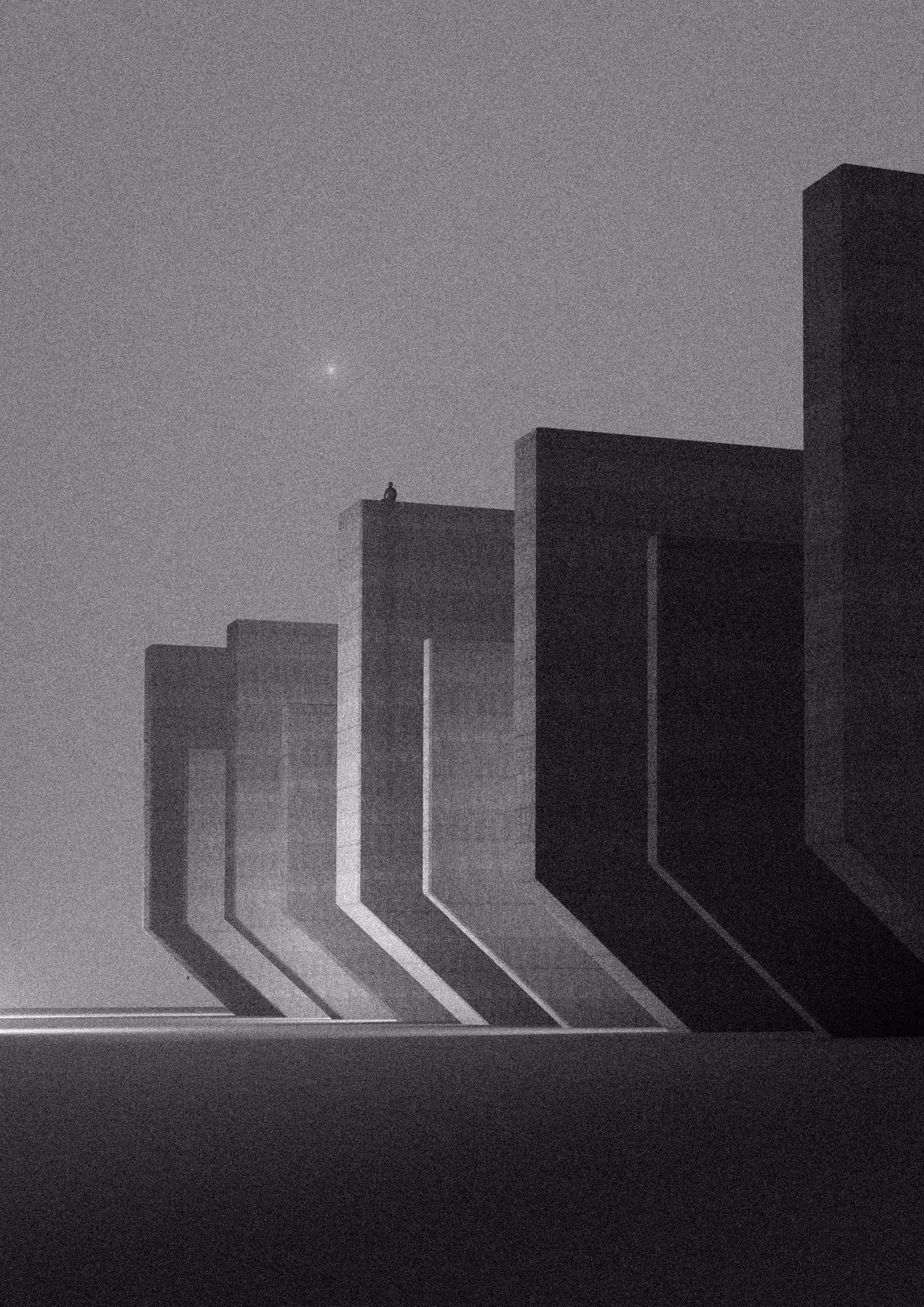 A lone figure sits atop one of a row of stepped concrete monoliths under a hazy sky, with a single star above.